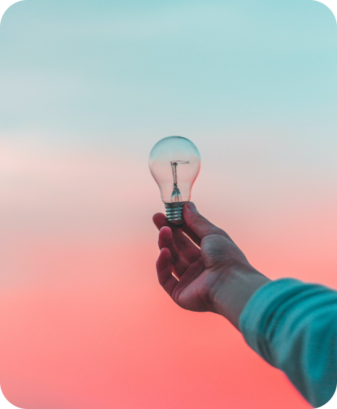 Hand holding light bulb